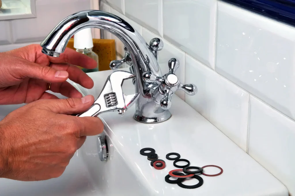 Plumber performing maintenance on a bathroom faucet in Riverview