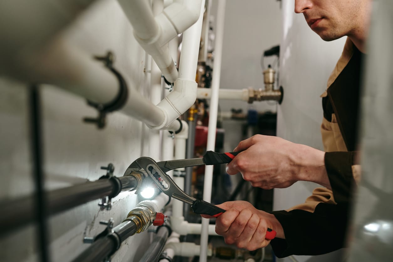 Plumbers maintaining commercial plumbing pipes in Riverview
