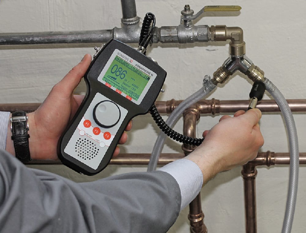 Plumber testing pipes with electronic leak detection equipment in Riverview