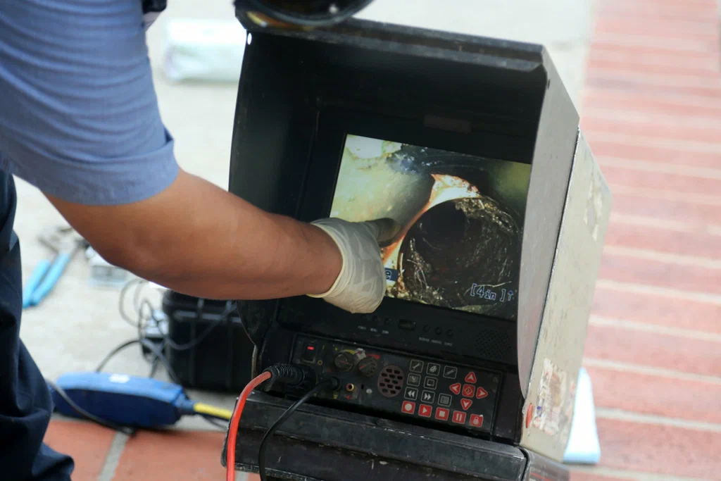 Technician viewing a drain inspection camera in Riverview