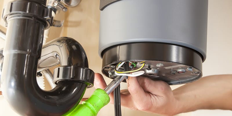 Technician repairing the heating element of a water heater in Riverview